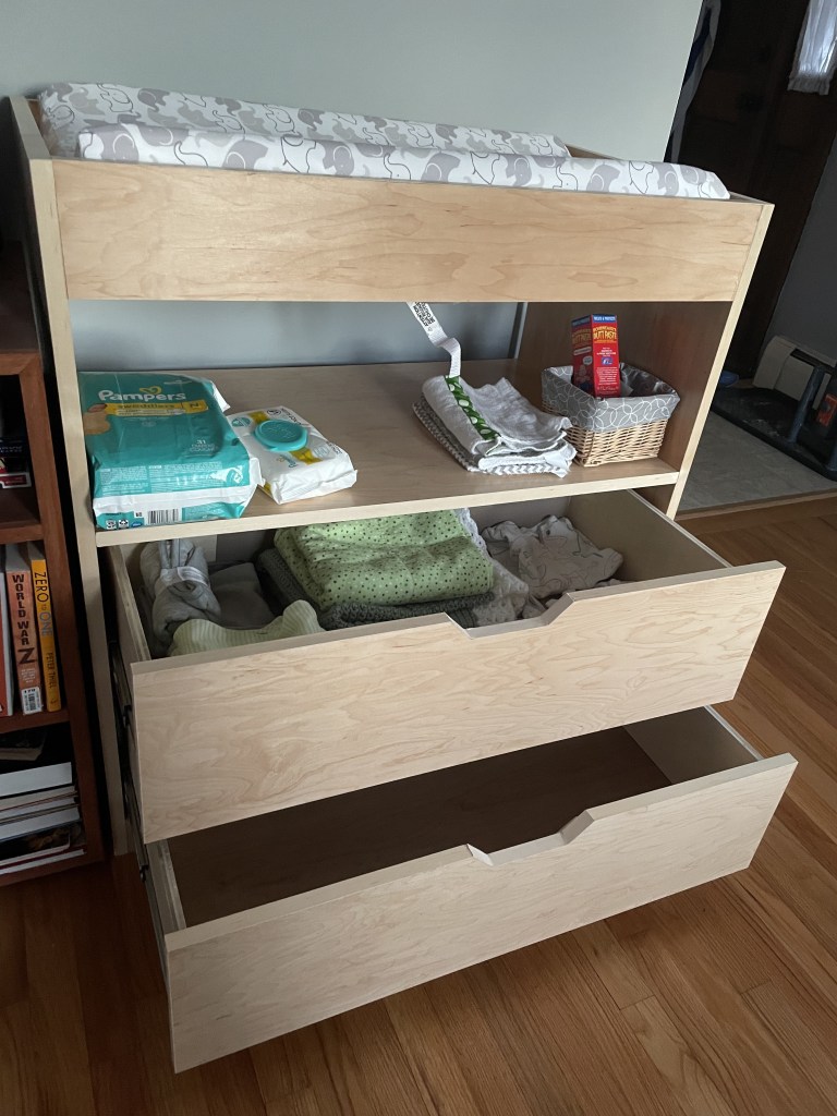 Drawers open on the maple changing table